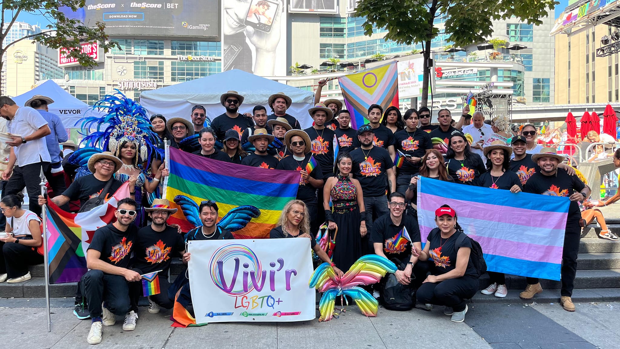 VIVI'R group with Pride and trans flags at Dundas Square