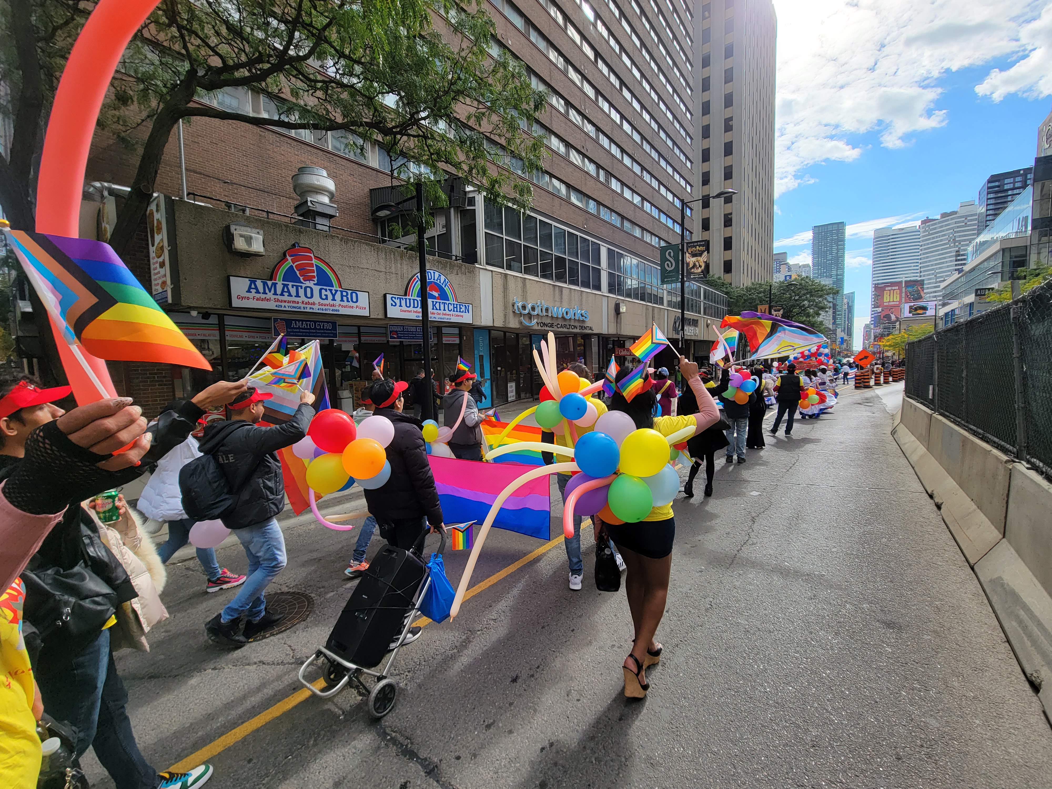Pride parade with balloons and flags